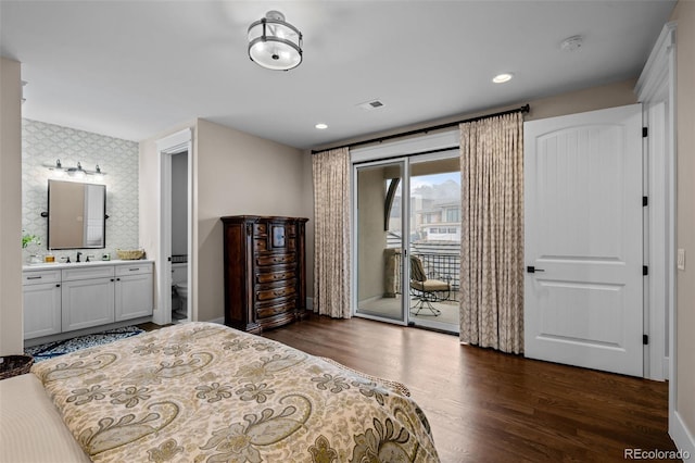 bedroom with ensuite bath, dark wood finished floors, access to exterior, recessed lighting, and visible vents