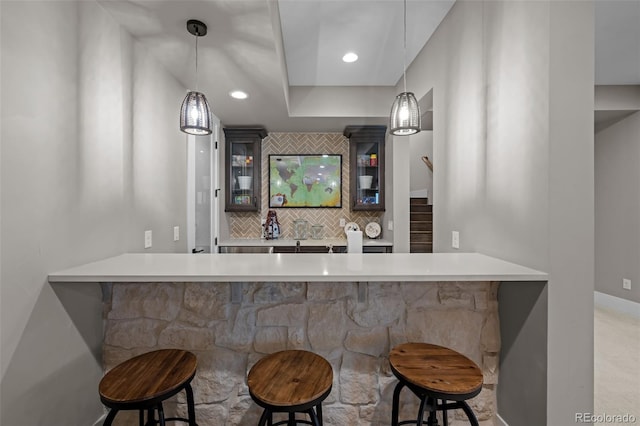 bar featuring pendant lighting, recessed lighting, tasteful backsplash, and stairs
