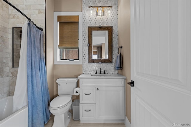 bathroom featuring vanity, shower / bath combo, and toilet