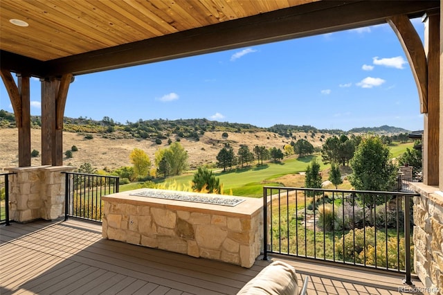 deck with a mountain view and golf course view