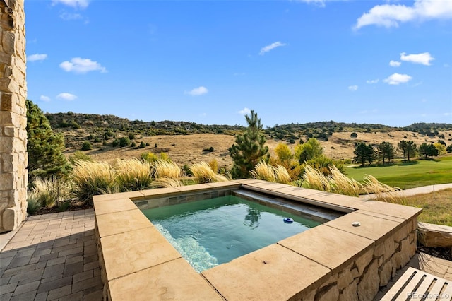 view of pool with an in ground hot tub