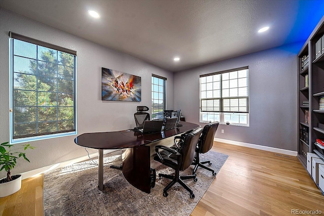 office with a healthy amount of sunlight and light wood-type flooring