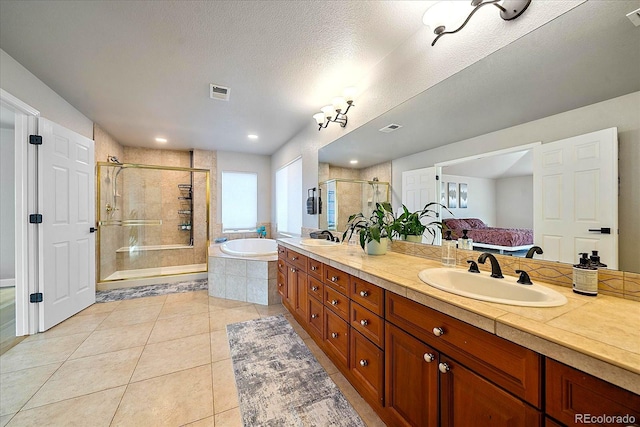 bathroom with tile patterned floors, separate shower and tub, and vanity