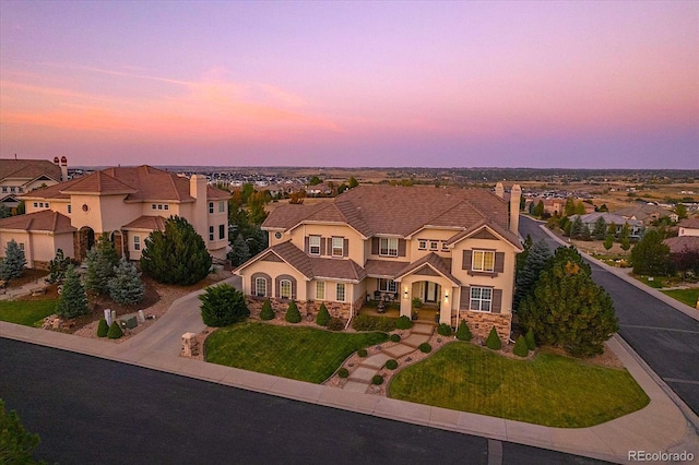 view of front of property with driveway, stone siding, a residential view, a tiled roof, and stucco siding