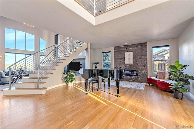 foyer entrance featuring hardwood / wood-style flooring and a stone fireplace