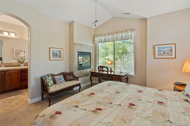10064 Bluffmont Ct, Lone Tree, CO 80124 - bedroom featuring arched walkways, lofted ceiling, light carpet, and connected bathroom