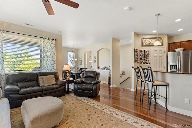 10064 Bluffmont Ct, Lone Tree, CO 80124 - living room with wood finished floors, recessed lighting, a ceiling fan, arched walkways, and a chandelier