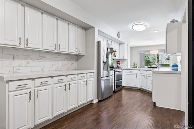 4976 S Nelson St Unit A, Littleton, CO 80127 - kitchen with appliances with stainless steel finishes, light countertops, tasteful backsplash, and white cabinets