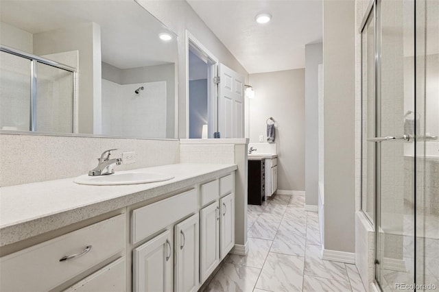 4976 S Nelson St Unit A, Littleton, CO 80127 - full bath with a stall shower, marble look tiles, two vanities, baseboards, and recessed lighting