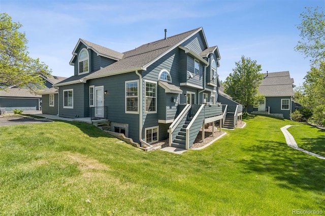 4976 S Nelson St Unit A, Littleton, CO 80127 - view of side of property featuring stairs, a yard, a deck, and a shingled roof