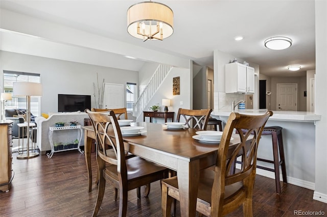 4976 S Nelson St Unit A, Littleton, CO 80127 - dining area featuring healthy amount of natural light, stairs, dark wood-style floors, and baseboards