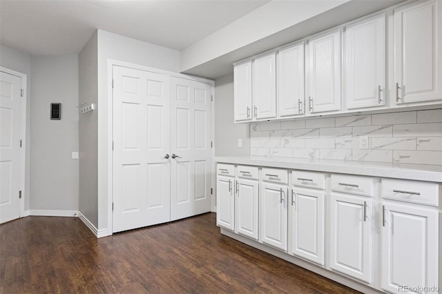 4976 S Nelson St Unit A, Littleton, CO 80127 - kitchen featuring backsplash, white cabinets, light countertops, and dark wood finished floors