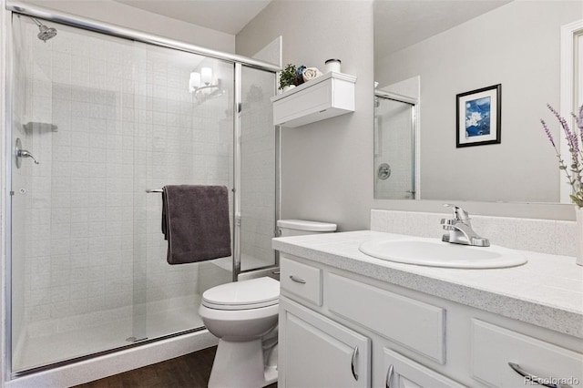 4976 S Nelson St Unit A, Littleton, CO 80127 - full bathroom featuring toilet, a shower stall, vanity, and wood finished floors