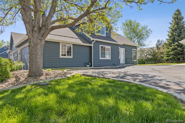 4976 S Nelson St Unit A, Littleton, CO 80127 - view of front of property featuring a front lawn and a shingled roof