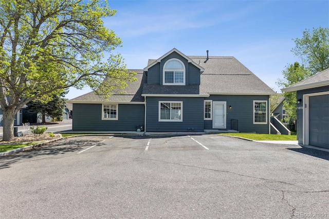 4976 S Nelson St Unit A, Littleton, CO 80127 - rear view of house with uncovered parking and roof with shingles