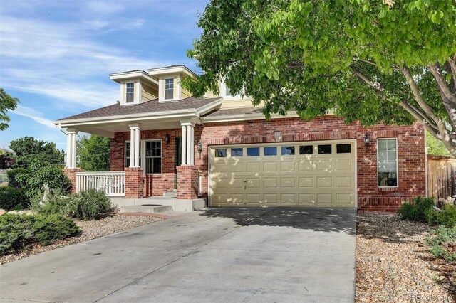 3109 S Jebel Way, Aurora, CO 80013 - view of front facade with covered porch, driveway, brick siding, an attached garage, and roof with shingles