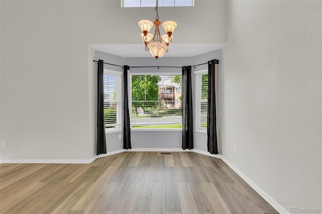 3109 S Jebel Way, Aurora, CO 80013 - unfurnished room featuring wood finished floors, a chandelier, and baseboards