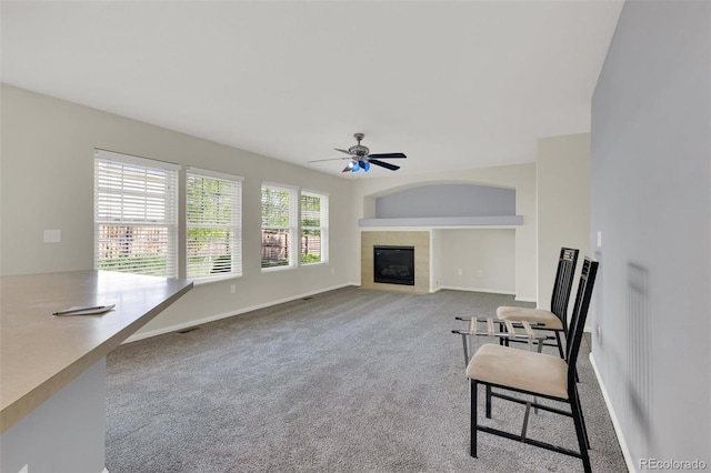 3109 S Jebel Way, Aurora, CO 80013 - unfurnished living room with a ceiling fan, carpet floors, a tile fireplace, and baseboards