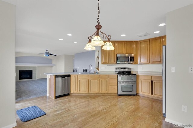 3109 S Jebel Way, Aurora, CO 80013 - kitchen featuring appliances with stainless steel finishes, a sink, recessed lighting, open floor plan, and light wood-style flooring