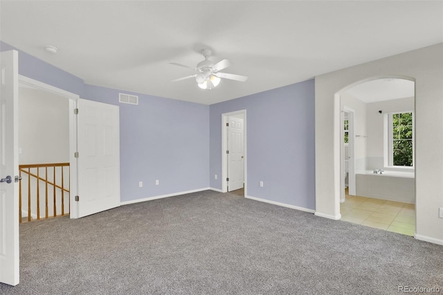 3109 S Jebel Way, Aurora, CO 80013 - spare room with arched walkways, carpet floors, ceiling fan, and baseboards