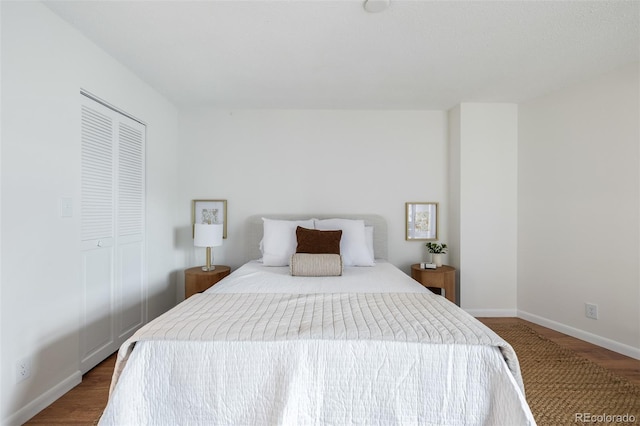 bedroom with hardwood / wood-style floors and a closet