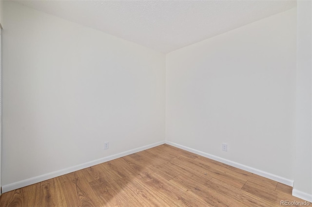 unfurnished room with light hardwood / wood-style floors