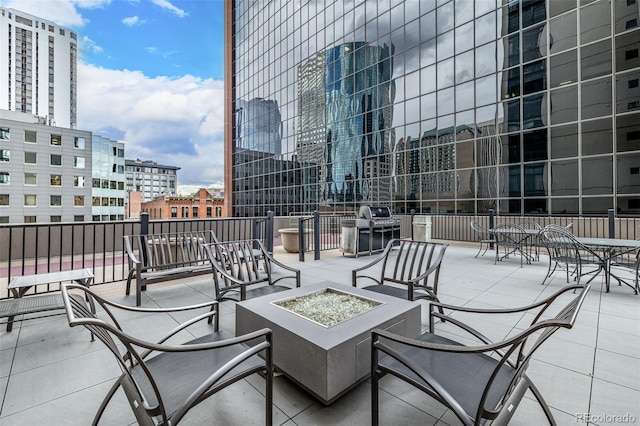 view of patio / terrace featuring an outdoor fire pit