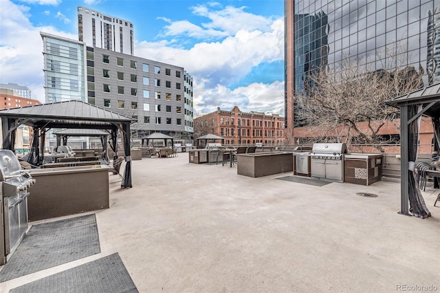 view of patio / terrace with a gazebo, a grill, and exterior kitchen