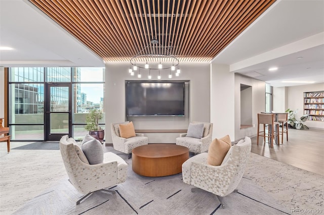 living room with hardwood / wood-style flooring and a wall of windows