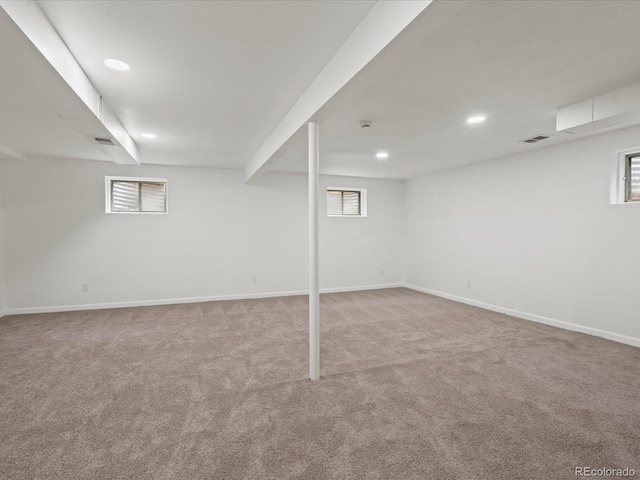 basement featuring carpet, baseboards, and recessed lighting