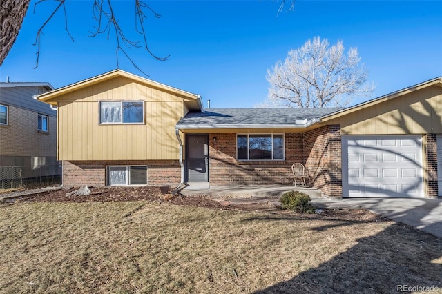 split level home featuring a front yard and a garage