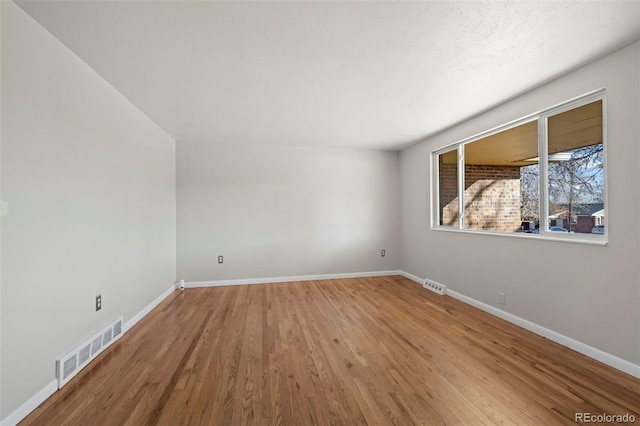 unfurnished room with wood-type flooring