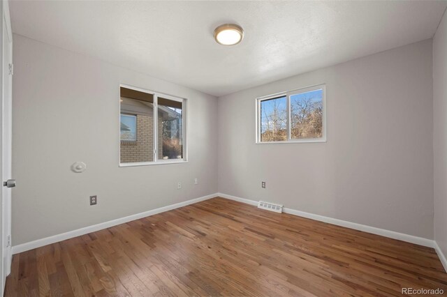 unfurnished room featuring hardwood / wood-style flooring