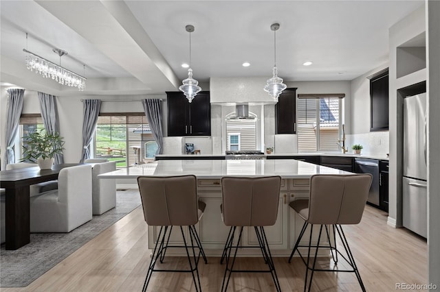 1815 Avery Way, Castle Rock, CO 80109 - kitchen with stainless steel appliances, light countertops, a kitchen island, decorative backsplash, and dark cabinetry
