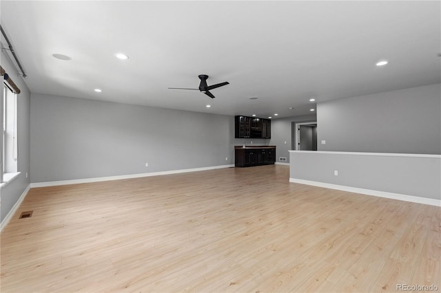 1815 Avery Way, Castle Rock, CO 80109 - unfurnished living room with a ceiling fan, light wood-style flooring, recessed lighting, and a barn door