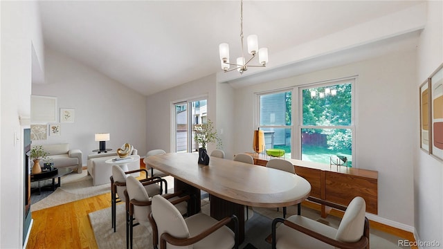 1006 Homestake Dr Unit 1D, Golden, CO 80401 - dining space featuring light wood finished floors, lofted ceiling, and a chandelier
