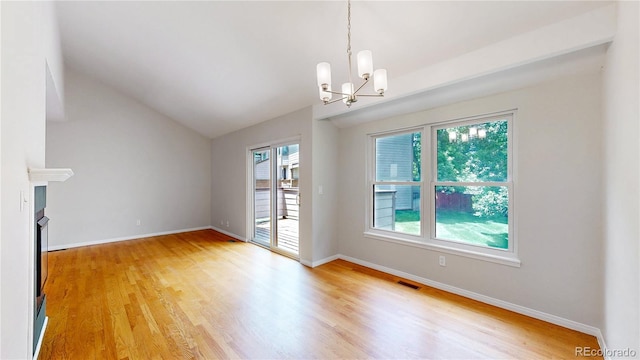 1006 Homestake Dr Unit 1D, Golden, CO 80401 - unfurnished living room featuring a chandelier, light wood-style floors, lofted ceiling, and a fireplace
