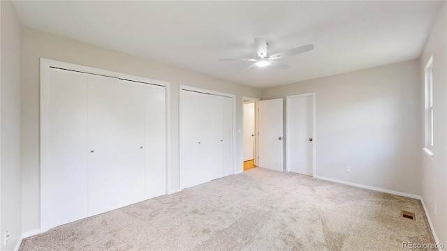1006 Homestake Dr Unit 1D, Golden, CO 80401 - unfurnished bedroom featuring carpet, two closets, and a ceiling fan