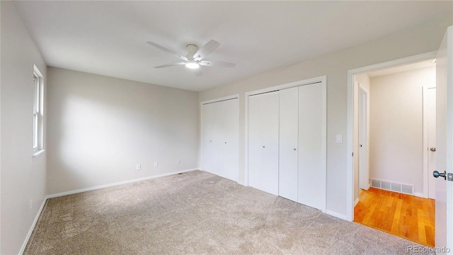 1006 Homestake Dr Unit 1D, Golden, CO 80401 - unfurnished bedroom featuring two closets, carpet flooring, and a ceiling fan