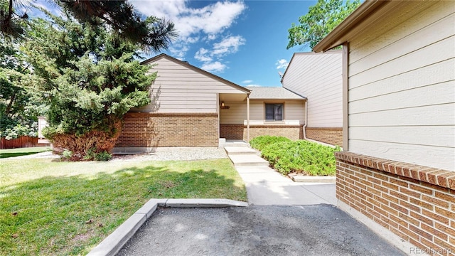 1006 Homestake Dr Unit 1D, Golden, CO 80401 - view of front facade with brick siding and a front lawn