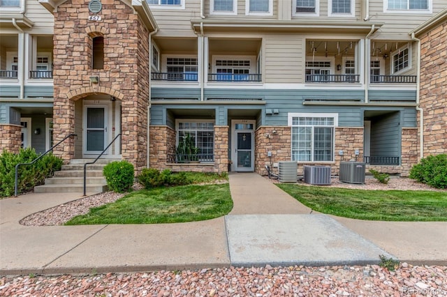 457 Black Feather Loop Unit 702, Castle Rock, CO 80104 - view of front of home featuring stone siding and central AC
