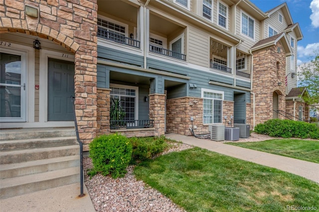 457 Black Feather Loop Unit 702, Castle Rock, CO 80104 - entrance to property with stone siding and central AC
