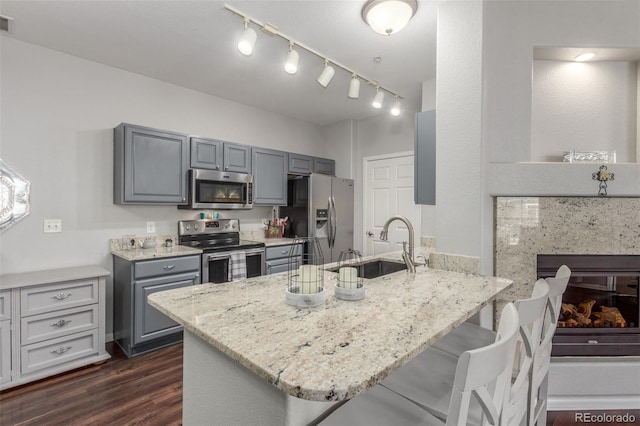 457 Black Feather Loop Unit 702, Castle Rock, CO 80104 - kitchen with appliances with stainless steel finishes, a peninsula, a sink, and gray cabinetry