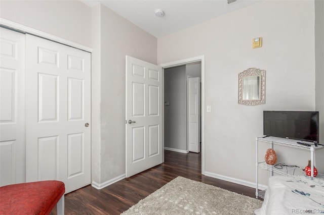 457 Black Feather Loop Unit 702, Castle Rock, CO 80104 - bedroom featuring wood finished floors, baseboards, and a closet