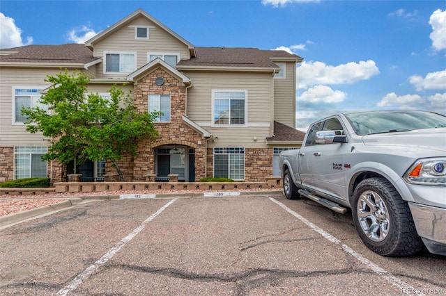 457 Black Feather Loop Unit 702, Castle Rock, CO 80104 - traditional-style home featuring stone siding and uncovered parking