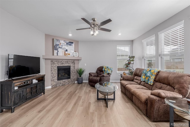 living room with ceiling fan and light wood-type flooring