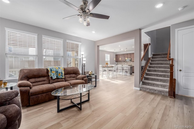 living room with ceiling fan and light hardwood / wood-style floors