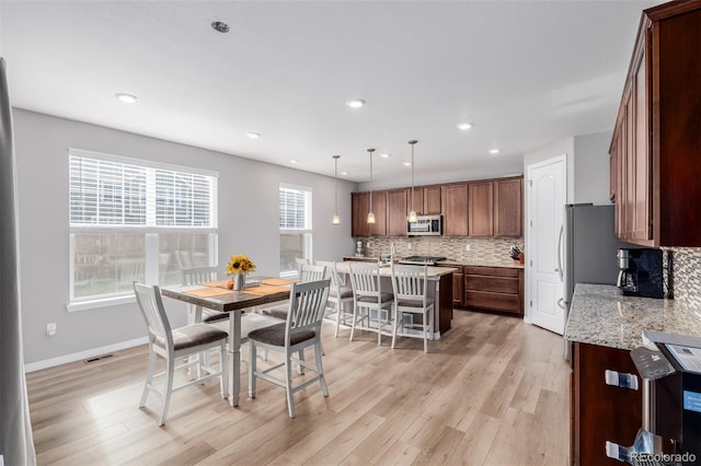 dining space with light wood-type flooring