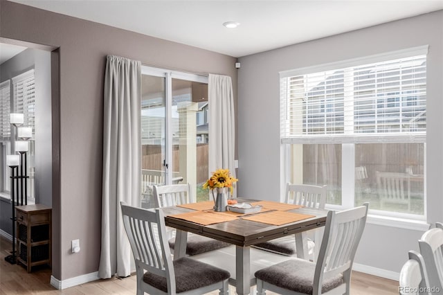 dining area with plenty of natural light and light wood-type flooring