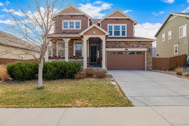 craftsman-style home with covered porch, a garage, and a front yard